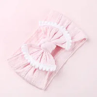 Cable knit pompom bow headband