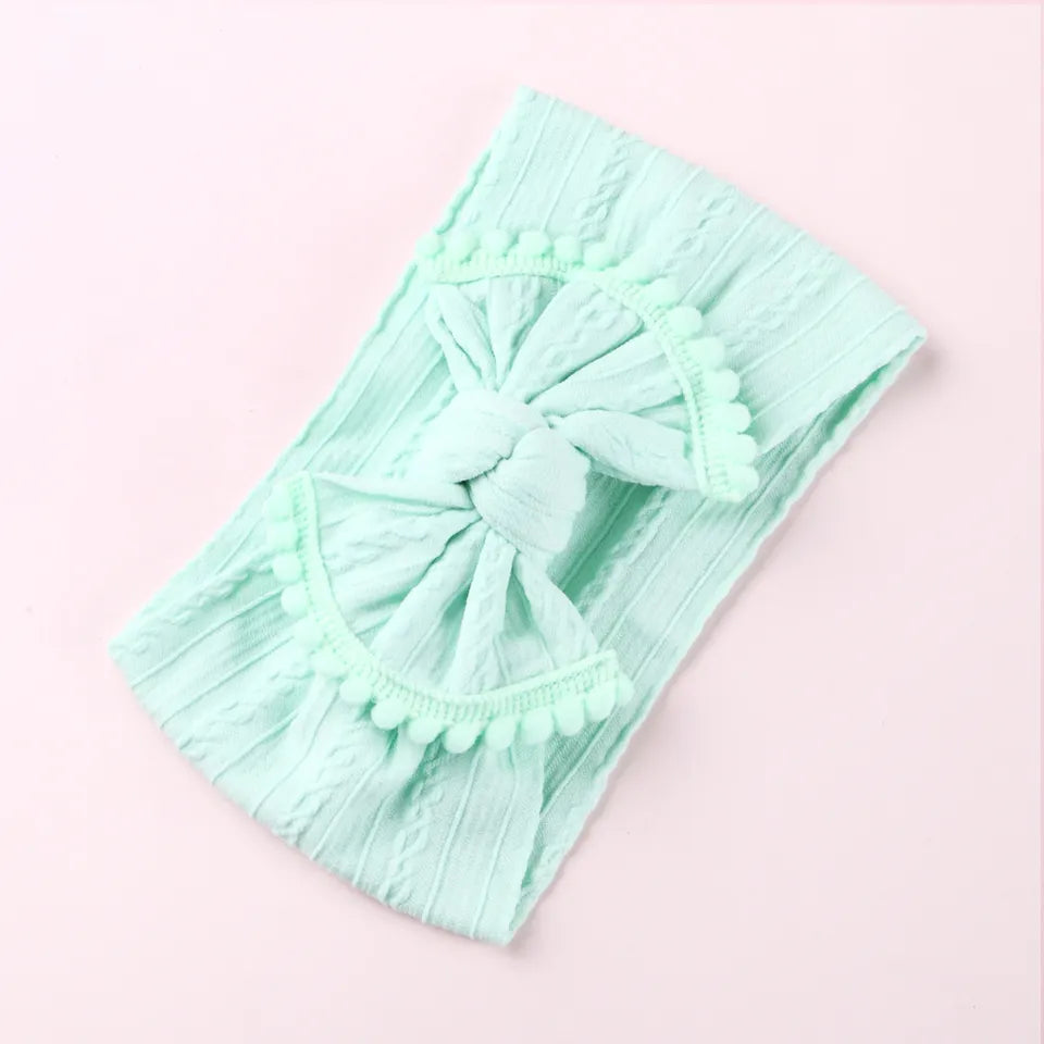 Cable knit pompom bow headband