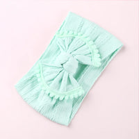 Cable knit pompom bow headband