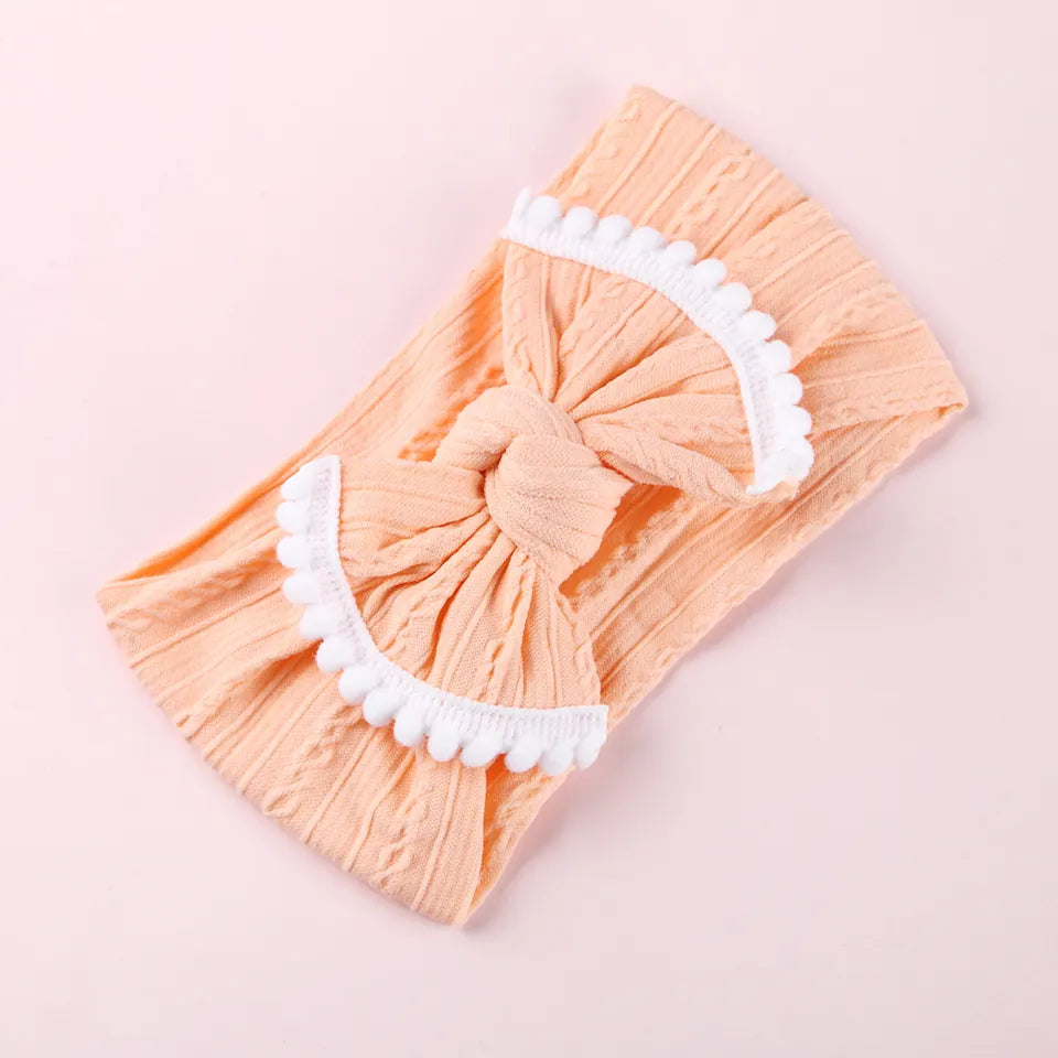 Cable knit pompom bow headband