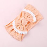 Cable knit pompom bow headband