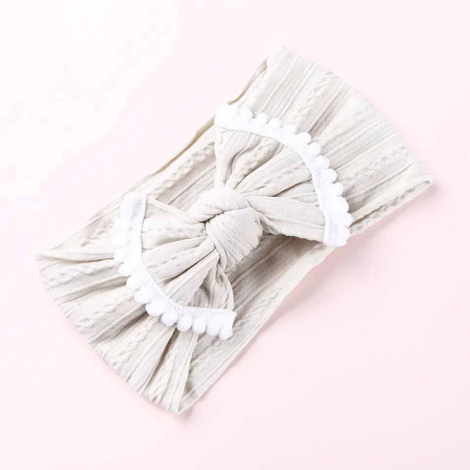 Cable knit pompom bow headband