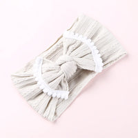 Cable knit pompom bow headband